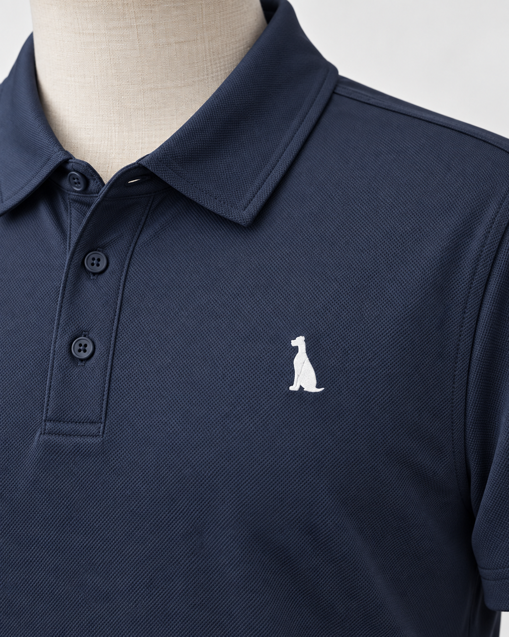 Close-up detail of the navy Golf Polo and seated Dane embroidery