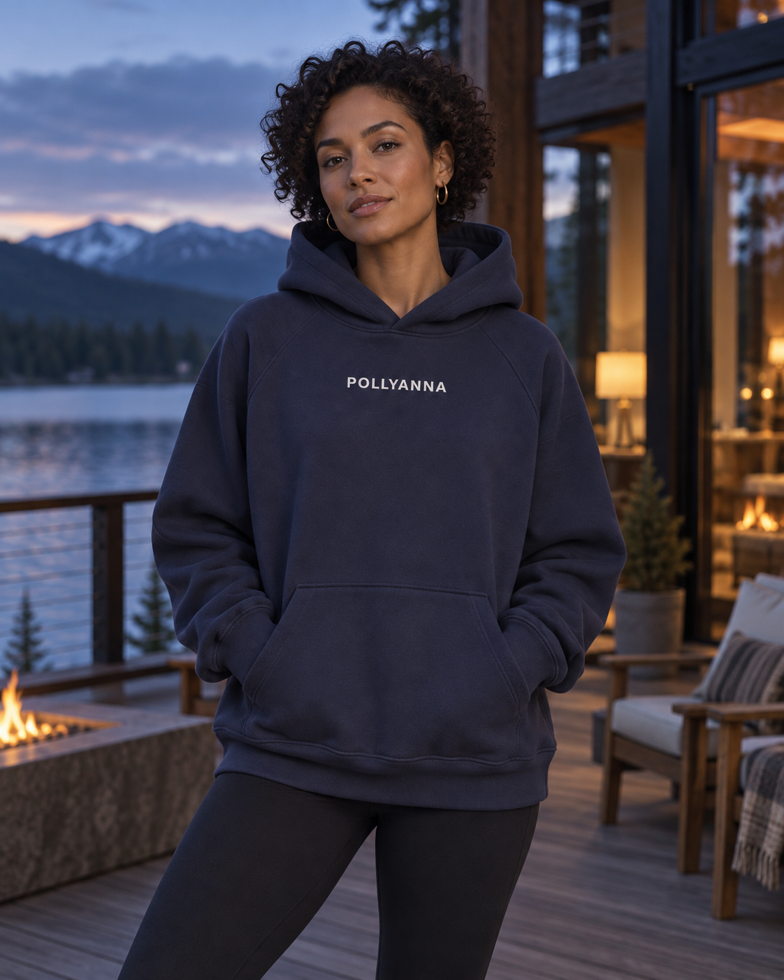 Woman wearing Eclipse IMY Hoodie at a lakeside lodge