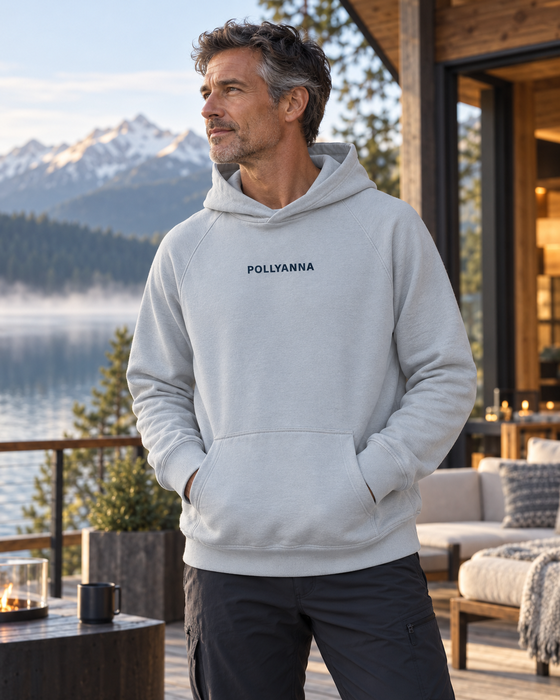 Mature male model wearing the mineral IMY Hoodie at a lakeside lodge