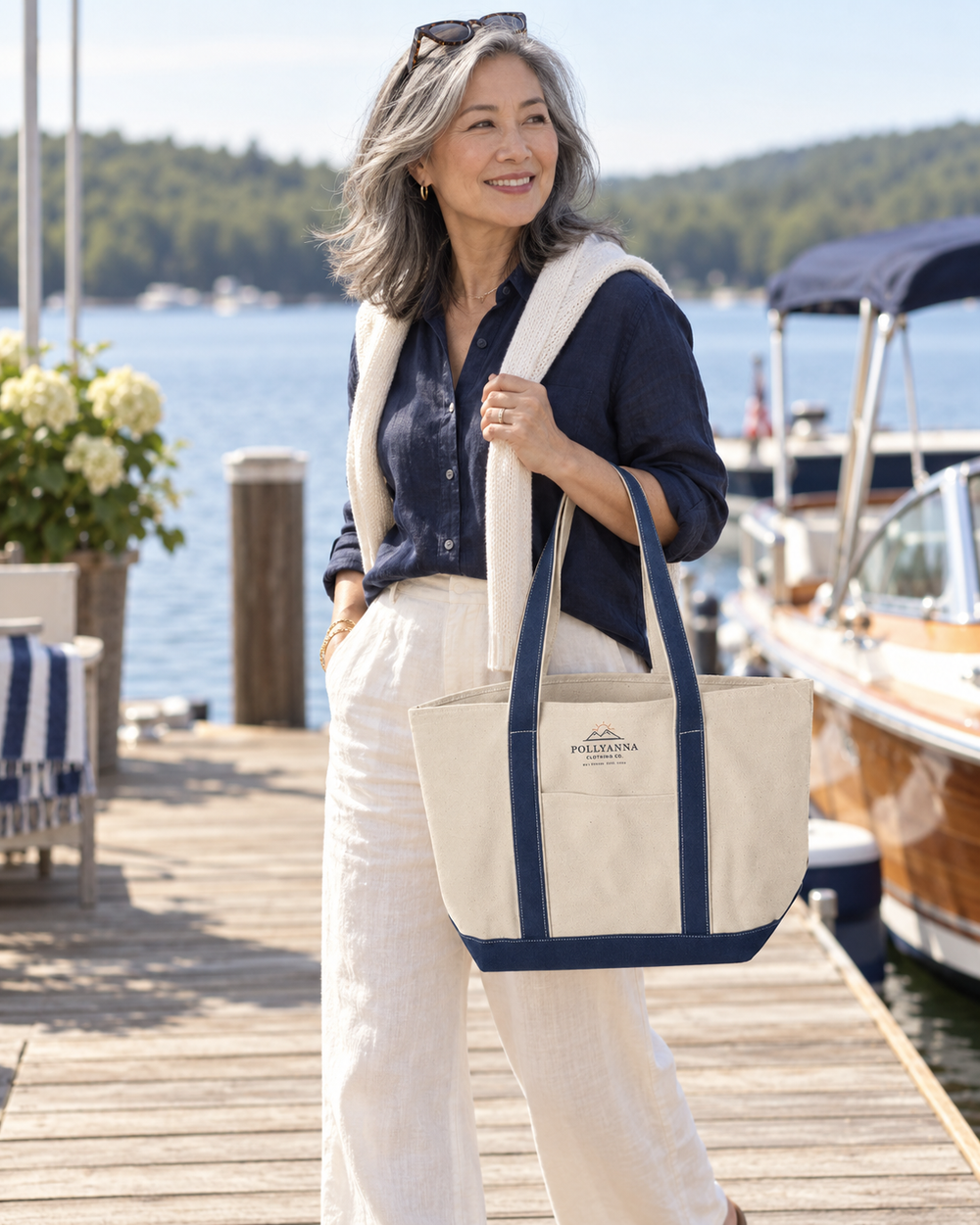 East Asian woman carrying the Pollyanna Lake Day tote at a lakeside marina